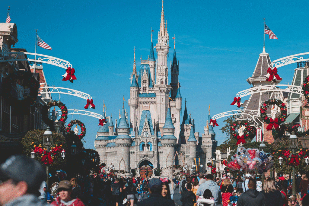 Crowd of people walking in front of Cinderella Castle at Disney World.
